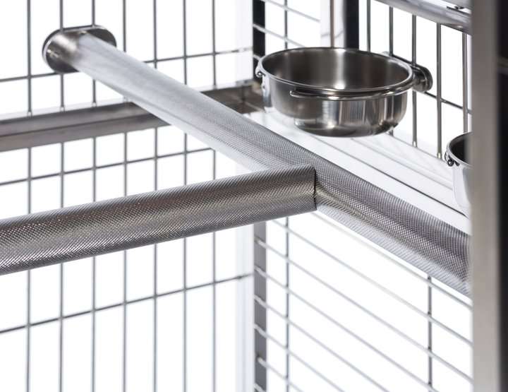 Metal birdcage with a stainless steel bowl inside