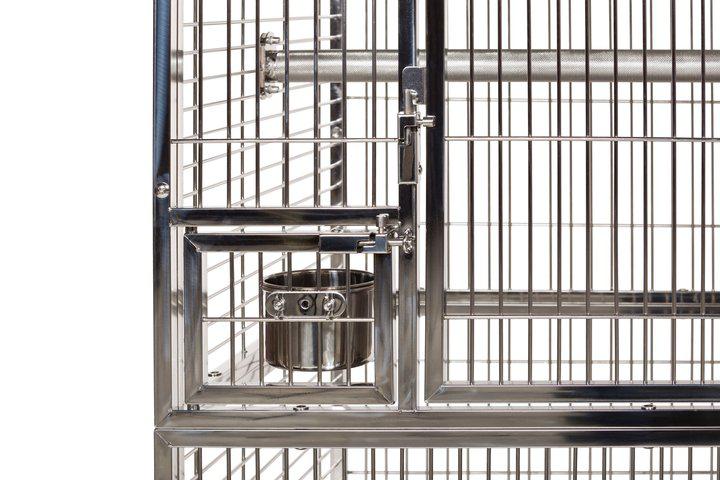 Metallic birdcage with a water dish on a white background